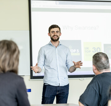 Image of postgraduate student giving a presentation