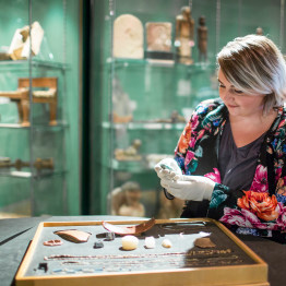 Museum curator handling Egyptian artefacts