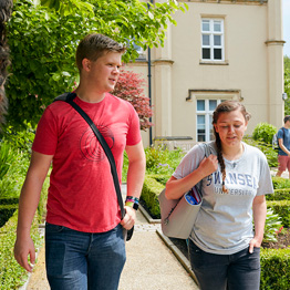 Male and female student walking next to Singleton Abbey