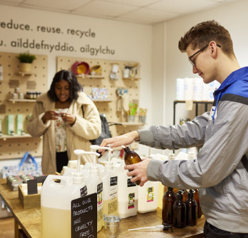 Two students shopping in the Root zero waste shop on campus