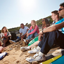 Group of students sitting on a beach